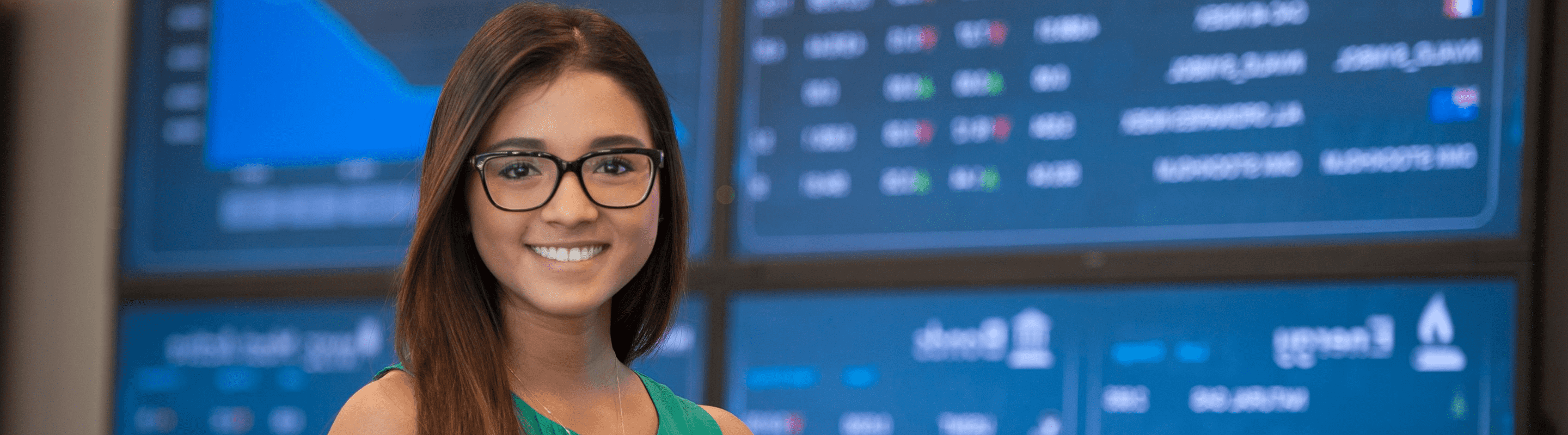 Online international business student in front of business stock tape.